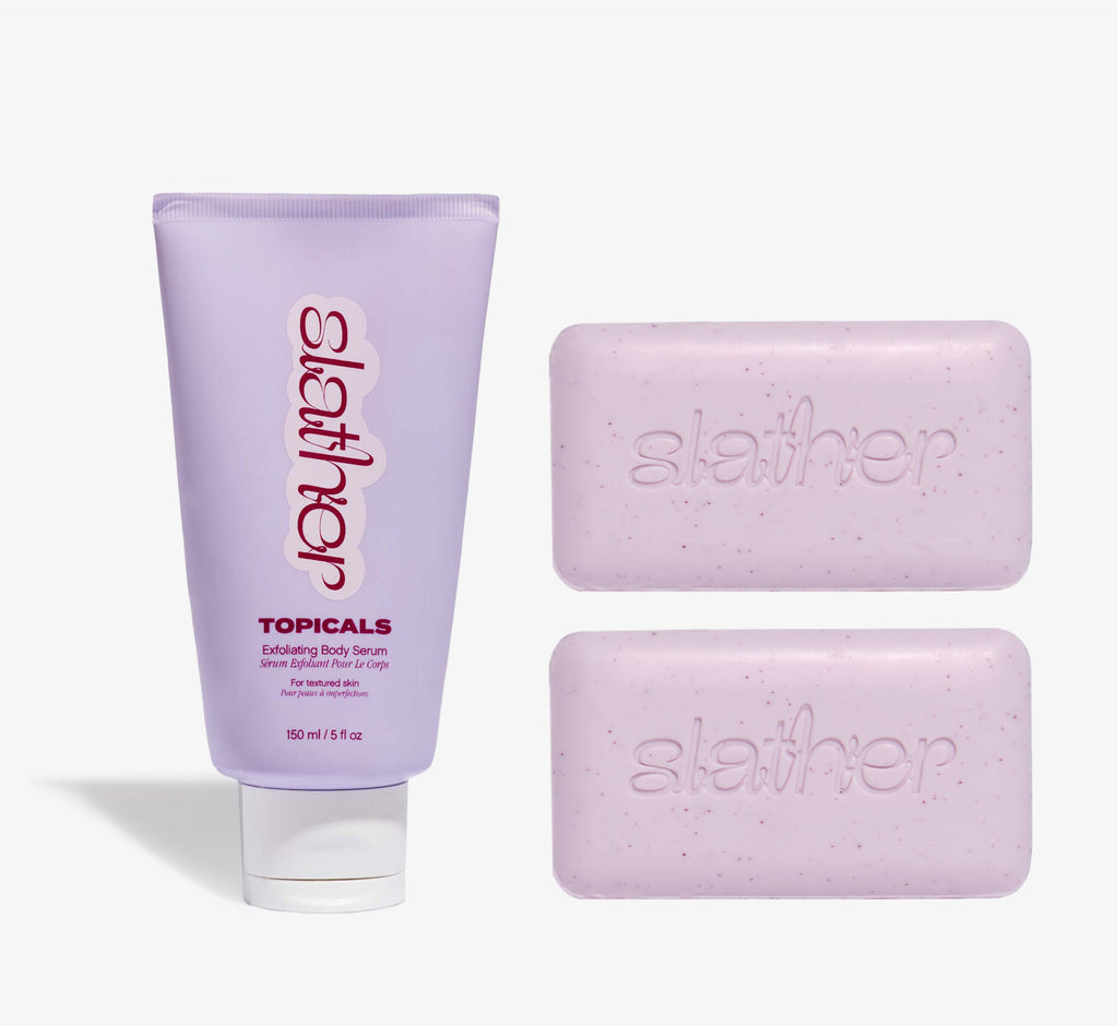 Exfoliating body care bundle from Topicals Slather featuring a lavender 150ml Exfoliating Body Serum tube alongside two pink Slather exfoliating cleansing bars on a white background.