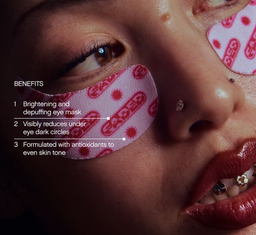 Under eye brightening patches from Topicals Faded shown applied beneath a model's eye, with callouts highlighting benefits including depuffing, reducing dark circles, and evening skin tone.